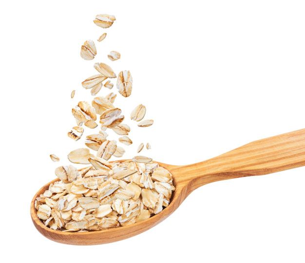 Isolated oatmeal, oat flakes in spoon, flying oat flakes isolated on white background with clipping path, falling oats collection