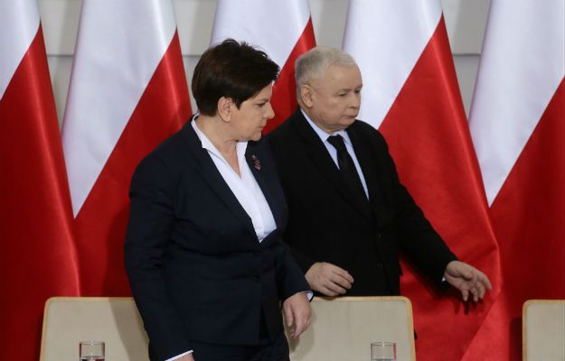 Jarosław Kaczyński jedną ręką czyni znak pokoju, a drugą zaczyna grozić