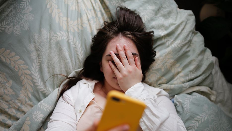 Sleepy overweight young woman with flowing hair using phone on bed, close face palm. Top view
Plus size young woman in home bedroom on bed with phone. Woman covering her eyes with her hand
Natalia  Lebedinskaia