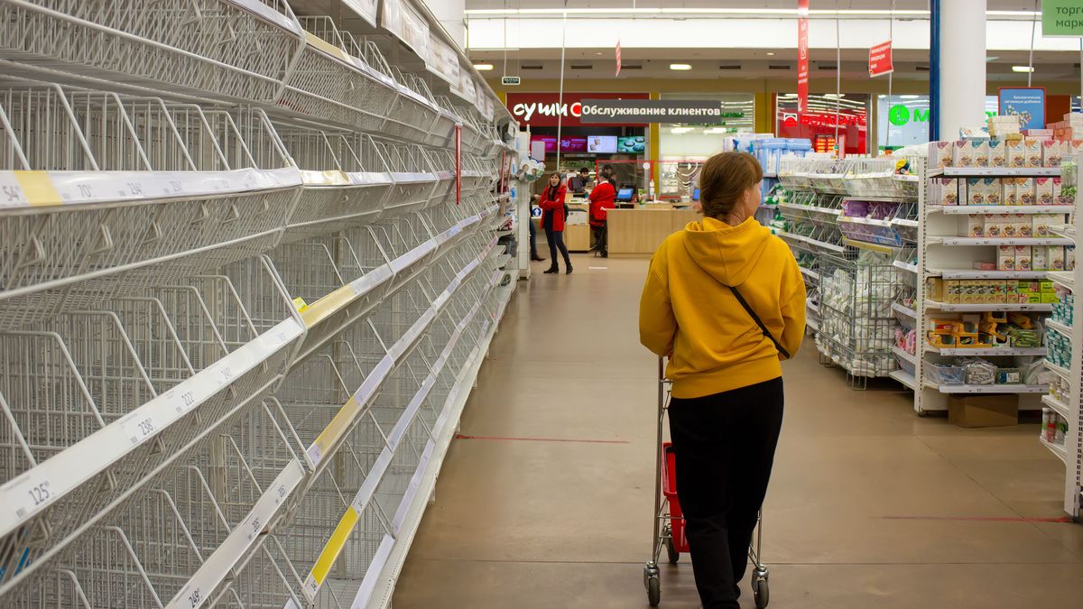 MOSCOW, RUSSIA - 2022/03/23: A woman walks by empty shelves in a supermarket in Moscow. There has been shortages of women's sanitary pads, diapers, and sugar after many foreign brands announced they were suspending their operations in Russia in light if the country's military operation in Ukraine. Besides these categories of goods, there has been no shortages of other fast-moving consumer goods in supermarkets in Russia. (Photo by Vlad Karkov/SOPA Images/LightRocket via Getty Images)