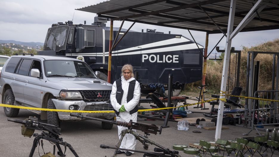 MITROVICA, KOSOVO - SEPTEMBER 25: A Kosovo Police officer at the Belvedere Police station during the display of weapons and supplies that were confiscated from an armed group on September 25, 2023 in MITROVICA, Kosovo. At least four people were killed, including one police officer, after Kosovan police cleared a monastery held by at least 30 heavily armed men near the border with Serbia. (Photo by Ferdi Limani/Getty Images)