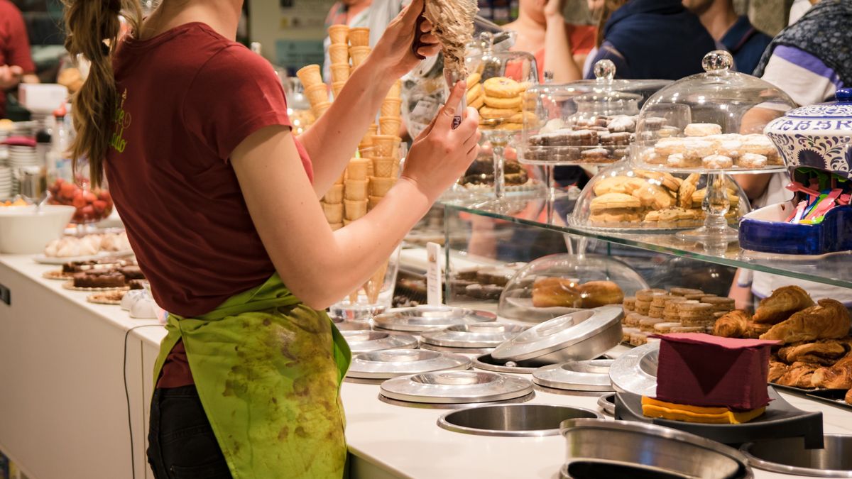 Behind the counter of an Italian ice cream shop.
colorful, cone, cornet, counter, cream, dessert, food, frozen, girl, hand, holes, ice, ice cream, ice cream cone, italian, making, occupation, preparation, preparing, presenting, saleswoman, sell, seller, shop, store, sweet, uniform, waffle cone, waiter, woman