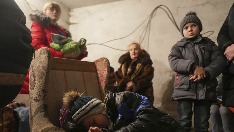 TemporaryA child sleep in an armchair as other stand around in a shelter during Russian shelling, in Mariupol, Ukraine, Thursday, Feb. 24, 2022. Russia launched a wide-ranging attack on Ukraine on Thursday, hitting cities and bases with airstrikes or shelling, as civilians piled into trains and cars to flee. Ukraine's government said Russian tanks and troops rolled across the border in a ??sfull-scale war??? that could rewrite the geopolitical order and whose fallout already reverberated around the world. (AP Photo/Evgeniy Maloletka)AP