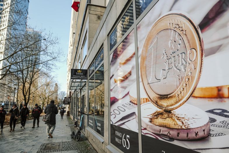 A euro coin illustration in the window of a building on Swietokrzyska street in central Warsaw, Poland, on Friday, Dec. 22, 2023. The central bank halted interest rate cuts after the Oct. 15 parliamentary election unexpectedly brought the pro-European Union opposition to power, along with their promises to boost budget spending. Photographer: Damian Lemaski/Bloomberg via Getty Images