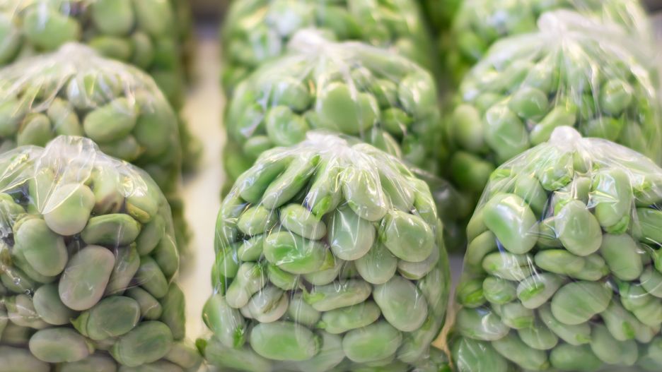 Broad beans inside plastic bags.Broad beans inside plastic bags in a market.BeSilvestre