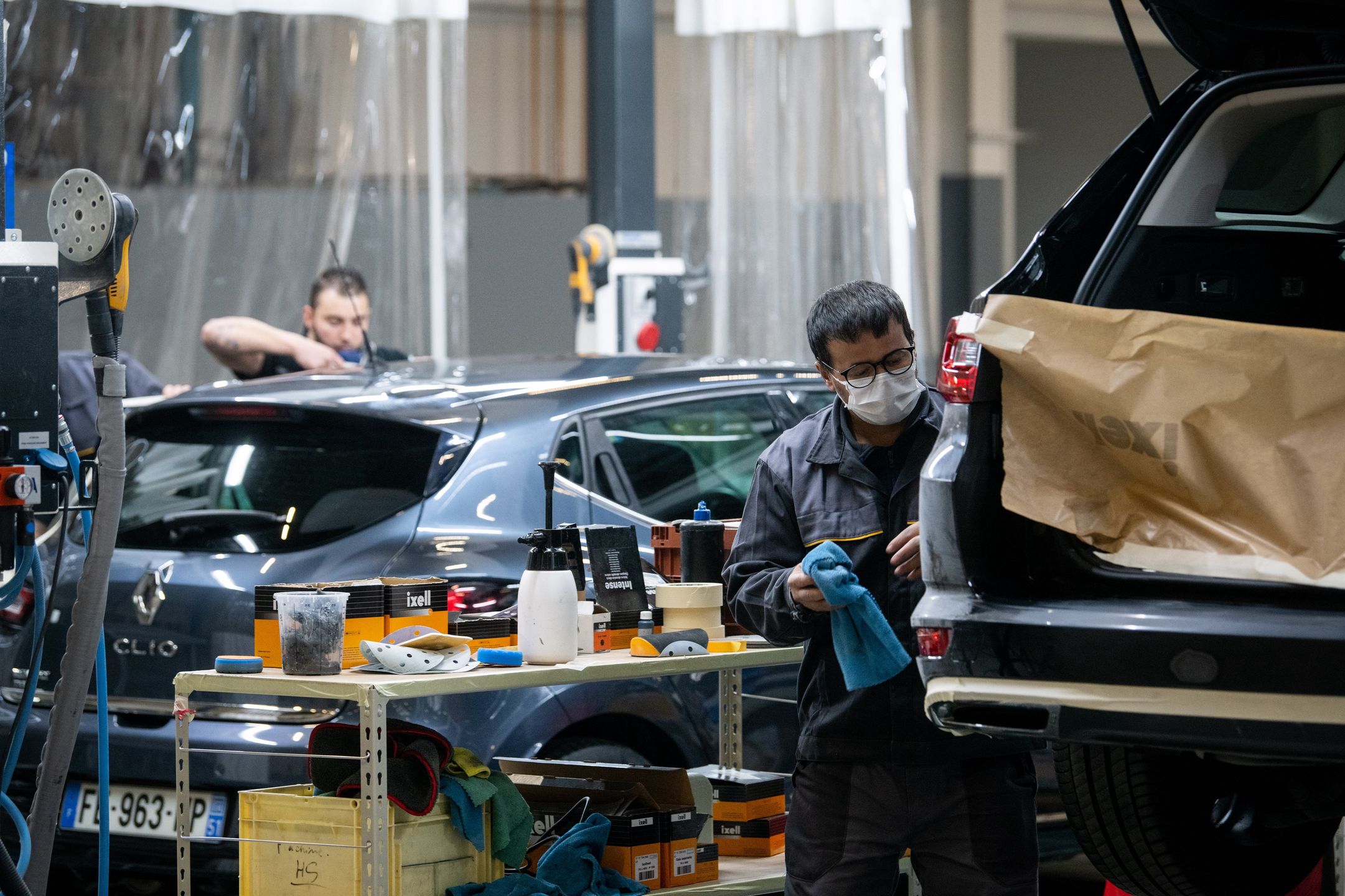 Technicians work on used vehicles at Renault SA's Re-Factory plant in Flins, France, on Tuesday, Nov. 30, 2021. The factory west of Paris, which makes the Zoe electric vehicle and the Nissan Micra, will transform by 2024 to recycle and retrofit cars and batteries. Photographer: Benjamin Girette/Bloomberg via Getty Images