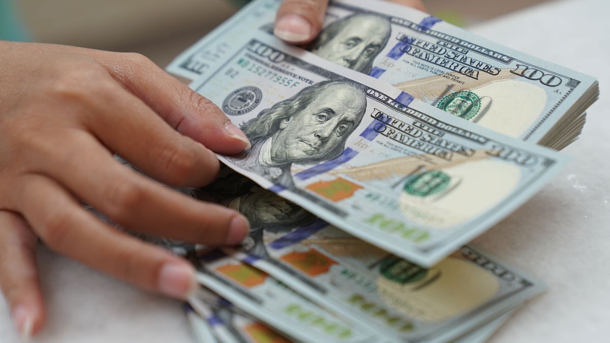 A worker counts U.S. dollar banknotes at a currency exchange office in Jakarta, Indonesia, on Wednesday, March 2, 2022. The dollar is rising against virtually every peer as fallout from the sanctions levied against Russia supercharge demand for the worlds reserve currency. Photographer: Dimas Ardian/Bloomberg via Getty Images