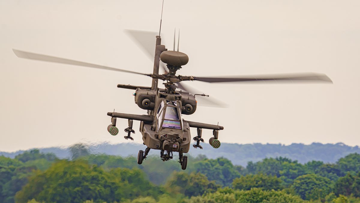 The Army Air Corps latest Apache AH-64E attack helicopter performs maneuvers over open countryside at the Army Aviation Centre at Middle Wallop, Stockbridge in Hampshire. Picture date: Tuesday July 12, 2022. (Photo by Ben Birchall/PA Images via Getty Images)