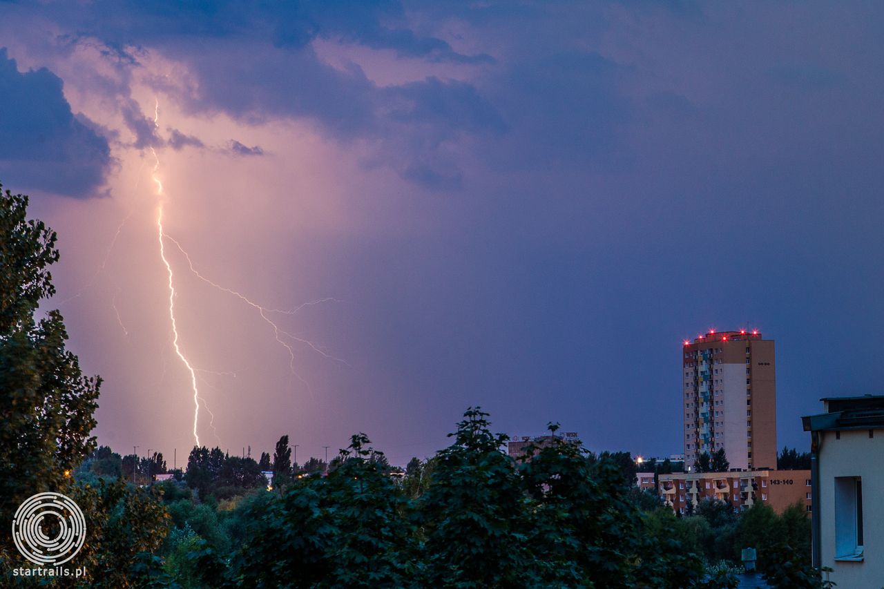 Poznańskie Rataje widok na północny wschód z 4 piętra klatki schodowej, wczesne godziny poranne tuż po wschodzie słońca. Wyładowania atmosferyczne za 16 piętrowymi wieżowcami. Canon EOS-1D Mark IV, Canon 24-70 mm f/2.8, ISO 400, F/9 T 10 s.