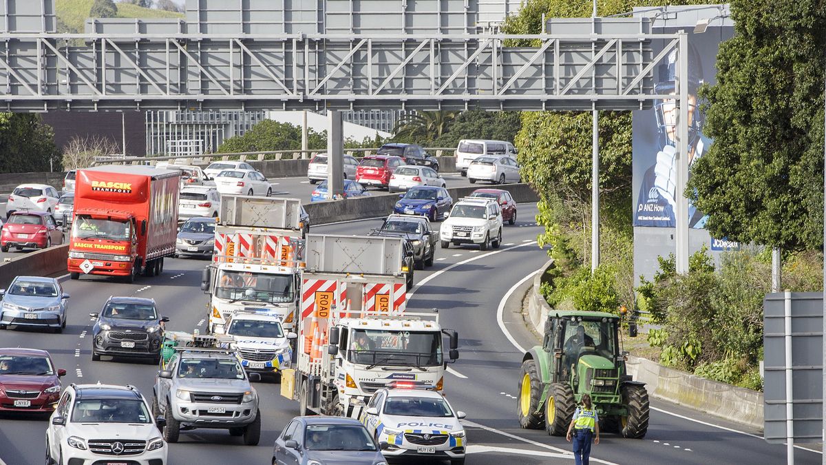 AUCKLAND, NEW ZEALAND - JULY 16: Tractors being driven by farmers and protesters on the motorway into Auckland causing congestion as they express their views on July 16, 2021 in Auckland, New Zealand. Farmers and rural residents are protesting around New Zealand over new government regulations on diesel and higher emission vehicles which has become known as the "ute tax." The NZ Government's Clean Car Package is a rebate scheme aimed at making lower-carbon-emitting cars more affordable while also adding fees on new, higher-emission vehicles, including utes. (Photo by Dave Rowland/Getty Images)