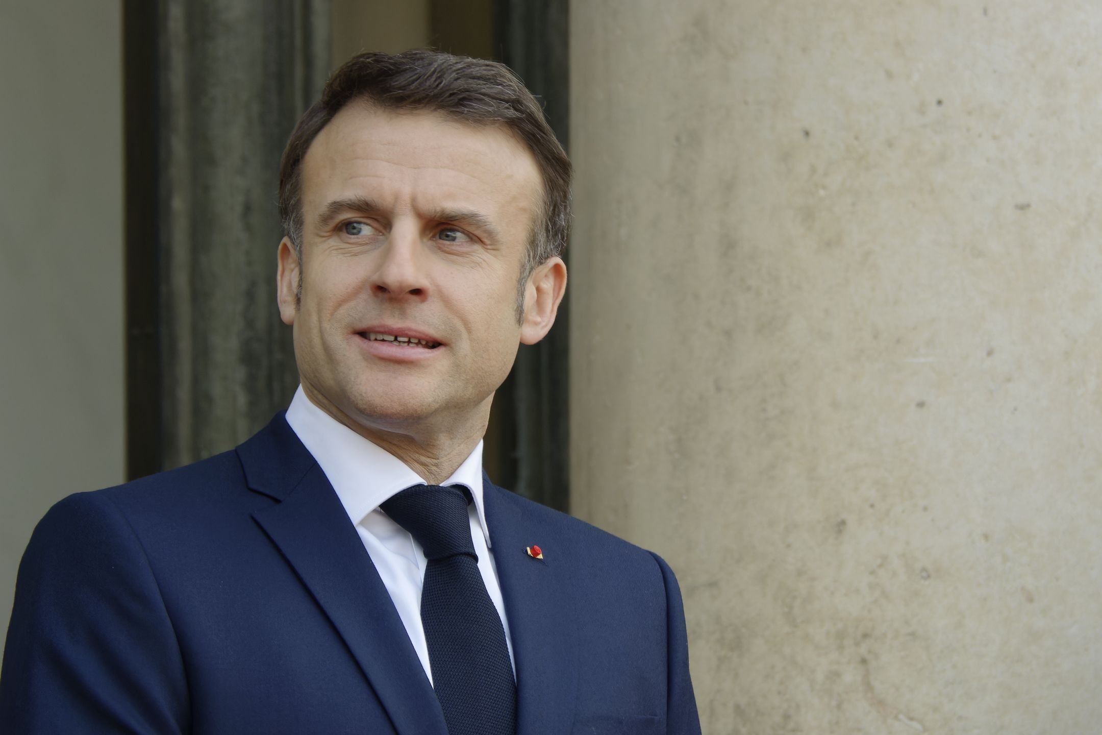 French President Emmanuel Macron is standing before the arrival of Qatar's Emir Sheikh Tamim bin Hamad al-Thani during an official visit to the Elysee Palace in Paris, France, on February 27, 2024. (Photo by Daniel Pier/NurPhoto via Getty Images)