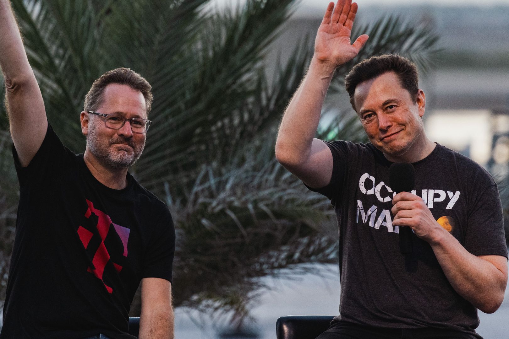 Elon Musk, co-founder and chief executive officer of Space Exploration Technologies Corp. (SpaceX) and Tesla Inc., right, with Mike Sievert, president and chief executive officer of T-Mobile US Inc., during a news conference at the SpaceX Starbase facility in Boca Chica, Texas, US, on Thursday, Aug. 25, 2022. T-Mobile is partnering with Elon Musks SpaceX to offer wireless phone service in remote parts of the US where coverage is spotty. Photographer: Jordan Vonderhaar/Bloomberg via Getty Images