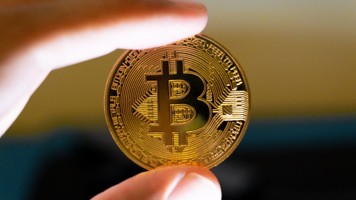 A macro shot of a man's hand holding a Bitcoin representation is seen in Athens, Greece, on September 4, 2025. (Photo by Nikolas Kokovlis/NurPhoto via Getty Images)