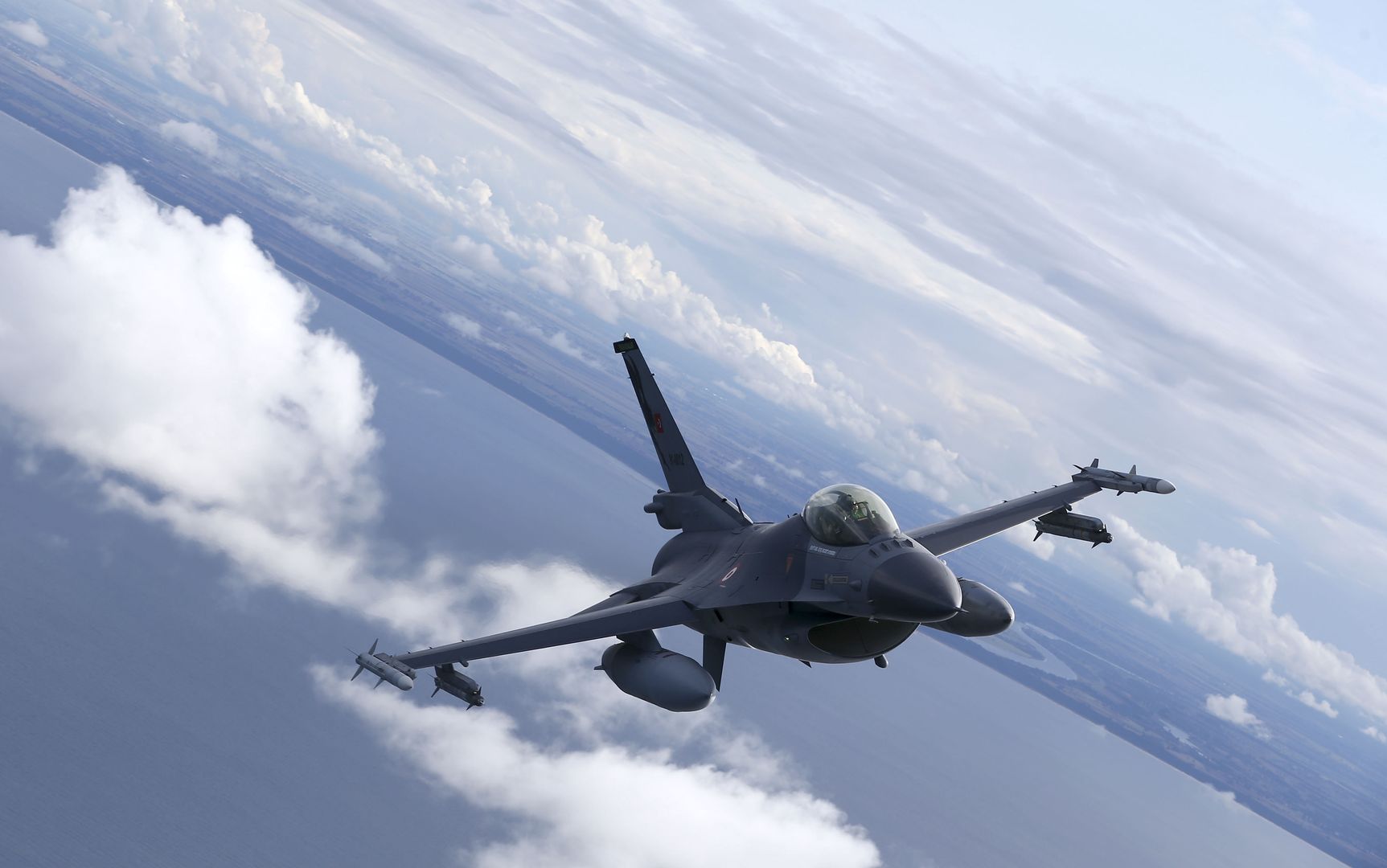 MALBORK, POLAND - AUGUST 27: Turkish F-16 fighter jet pilots fly by C-295M Casa military cargo plane of Poland as F-16 fighter jets of Turkish Air Forces serve in NATO's "Air Policing" mission at 22nd Air Base Command in Malbork, Poland on August 27, 2021. (Photo by Cuneyt Karadag/Anadolu Agency via Getty Images)