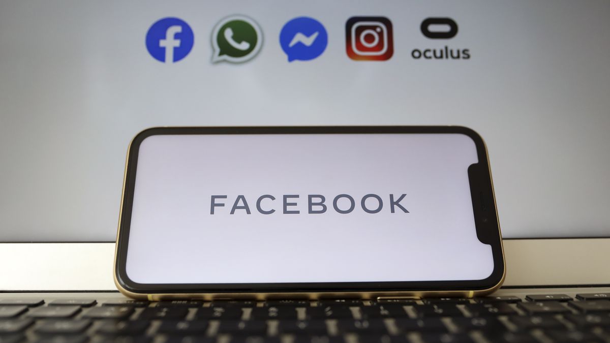ANKARA, TURKEY - MAY 4: In this illustration photo, Facebook logo is displayed on a smart phone as logo of social media applications  Facebook, WhatsApp, Instagram, Messenger and Oculus are seen behind, in Ankara, Turkey on May 4, 2020. (Photo by Hakan Nural/Anadolu Agency via Getty Images)