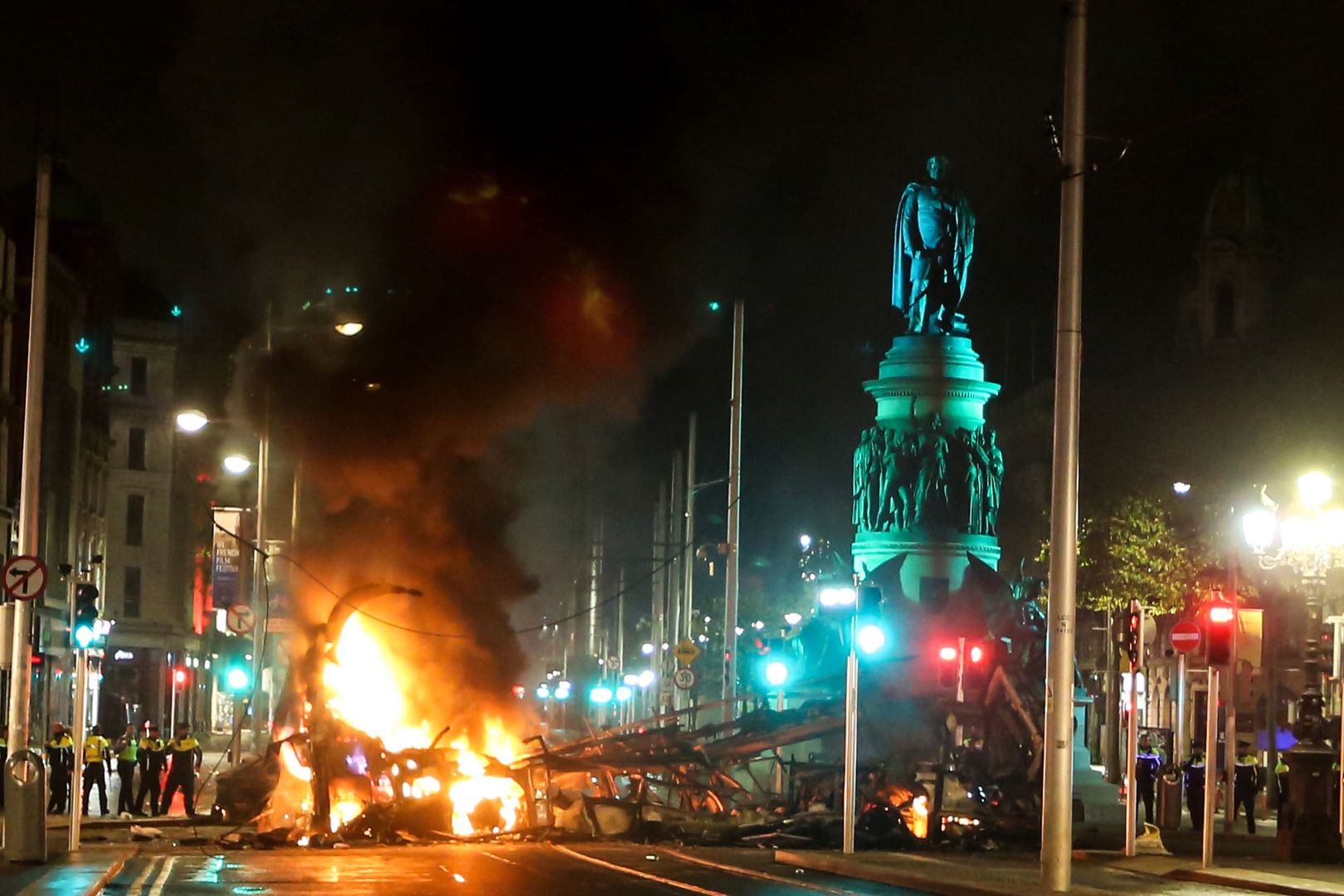 DUBLIN, IRELAND - NOVEMBER 23: A vehicle in flames in O'Connell Street after violence broke out following five people were wounded in a stabbing attack, including three children and a woman, in Ireland's capital Dublin on November 23, 2023. (Photo by Stringer/Anadolu via Getty Images)