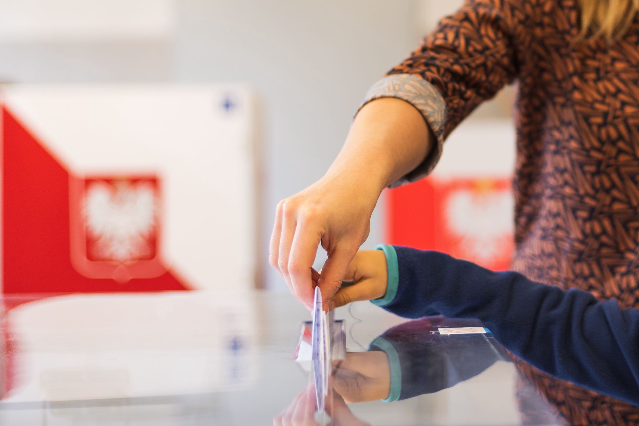 Woman's and kid's hands puting a card with a vote
to the ballot box during parliamentary elections. In the backround polish arms and flag
P.Dziurman/REPORTER
vote, ballot, box, elections, woman, kid, child, son, mother, choice, urn, voice, devotion, card, paper, list, illustration, throwing, hand, stock, emblem, flag, eagle, Election, Committee, Sejm, Senate, parliamentary, hand, polish, flag, arms, Poland, parliamentary, hand, throw, background, concept, illustration, government, white, red, symbol, young, youth, boy, girl, lifestyle, ballot box, vote, ballot, box, elections, woman, kid, child, son, mother, choice, urn, voice, devotion, card, paper, list, illustration, throwing, hand, stock, emblem, flag, eagle, election, committee, sejm, senate, parliamentary, polish, arms, poland, throw, background, concept, government, white, red, symbol, young, youth, boy, girl, lifestyle, presidential elections, poll, polling