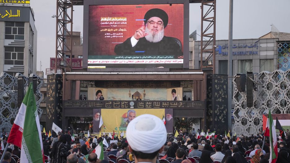 An Iranian cleric stands at a square in Tehran as Lebanon's Hezbollah Secretary-General Hassan Nasrallah gives a speech, November 3, 2023. Hassan Nasrallah spoke in Beirut about the Israeli army's attack on Gaza and warned Israel about a possible attack on Lebanon. (Photo by Morteza Nikoubazl/NurPhoto via Getty Images)