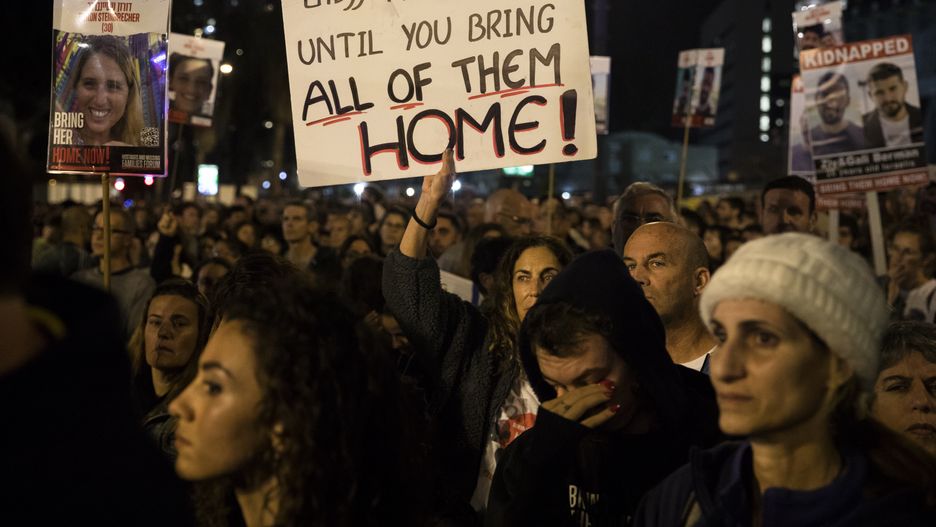 TEL AVIV, ISRAEL - JANUARY 06:  People hold signs and photos of hostages as they take part in a rally calling for the release of all hostages held in the Gaza Strip  on January 6, 2024 in Tel Aviv, Israel. More than 100 Israeli hostages captured on Oct. 7 remain held in Gaza by Hamas and other militant groups, according to Israeli authorities.  (Photo by Amir Levy/Getty Images)
