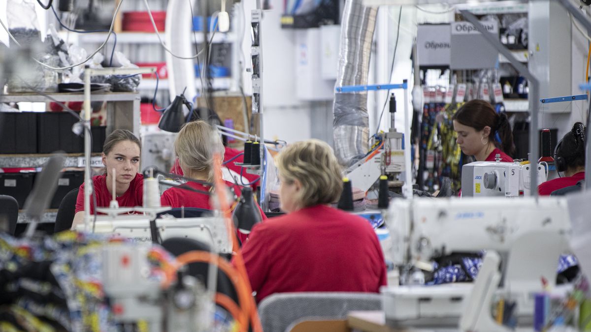 Employees use sewing machines to manufacture products at the Collar pet accessories factory in Chernihiv, Ukraine, on Monday, July 4, 2022. Four months after the invasion about 70% of the Collar's 600 staff are back working in the factory, where shrapnel-perforated roofs have been replaced, power and water restored and the goal is to recover to pre-war levels by the end of August, shipping everything from NASA dog collars to reversible, glow-in-the-dark canine puffer jackets to China, Europe, the US and beyond. Photographer: Andrew Kravchenko/Bloomberg via Getty Images