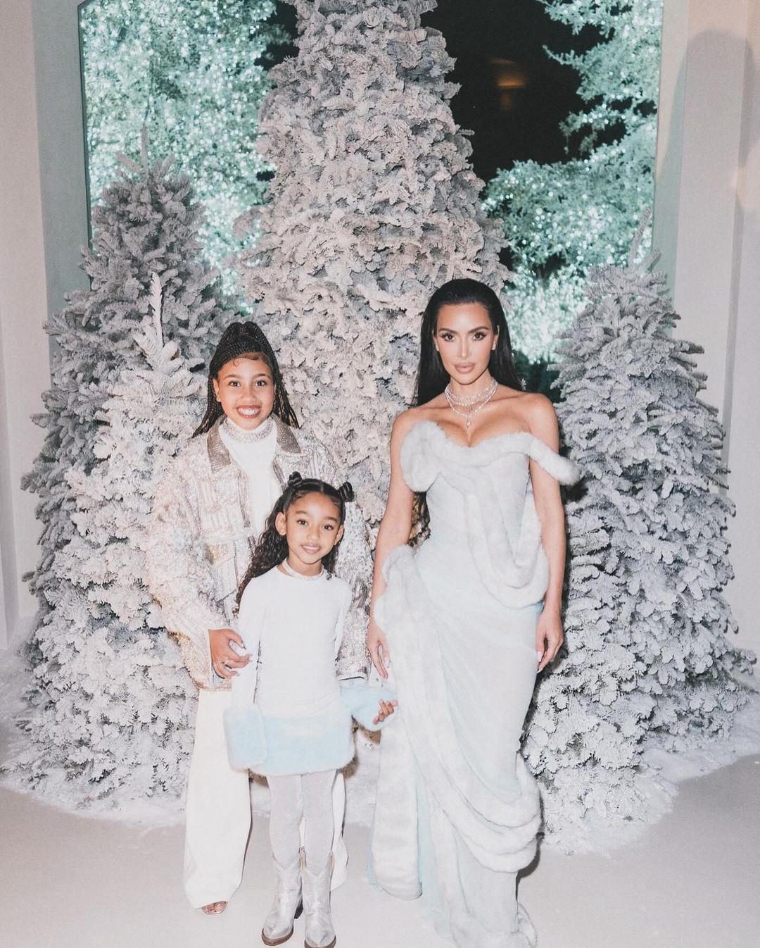 Kim Kardashian with kids at a holiday party