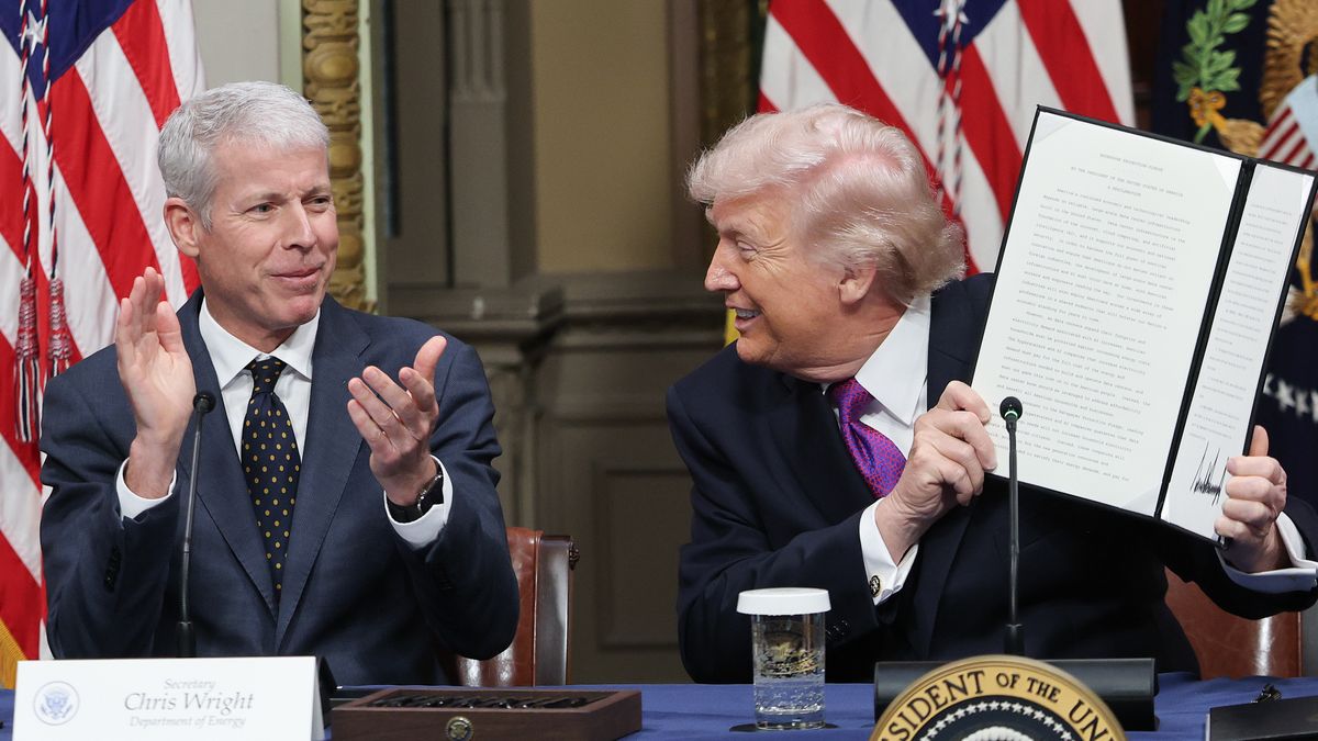 WASHINGTON, DC - MARCH 04: U.S. President Donald Trump holds up the Ratepayer Protection Pledge as U.S. Energy Secretary Chris Wright (L) looks after signing it during a roundtable meeting in the Indian Treaty Room at the White House on March 04, 2026 in Washington, DC. The pledge is a policy designed to shift rising energy costs from artificial intelligence data centers away from consumers. (Photo by Win McNamee/Getty Images)
