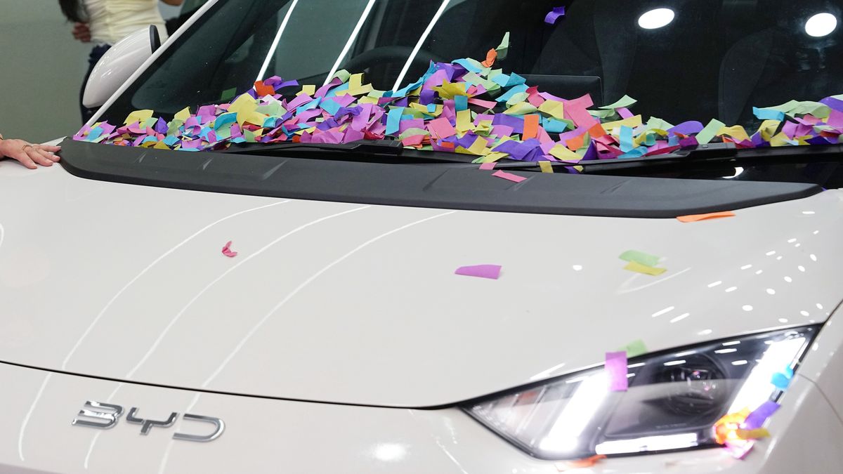 KATHMANDU, NEPAL - AUGUST 06: A visitor poses for a photo with BYD Seagull - rebranded as the BYD Atto 1 for the Nepali market - during the NAIMA Nepal Mobility Expo 2025 on August 6, 2025 in Kathmandu, Nepal. The NAIMA Nepal Mobility Expo 2025 officially commenced on August 6 at Bhrikutimandap Exhibition Hall in the capital city, marking a major milestone in Nepal's evolving automotive landscape. (Photo by Cui Nan/China News Service/VCG via Getty Images)