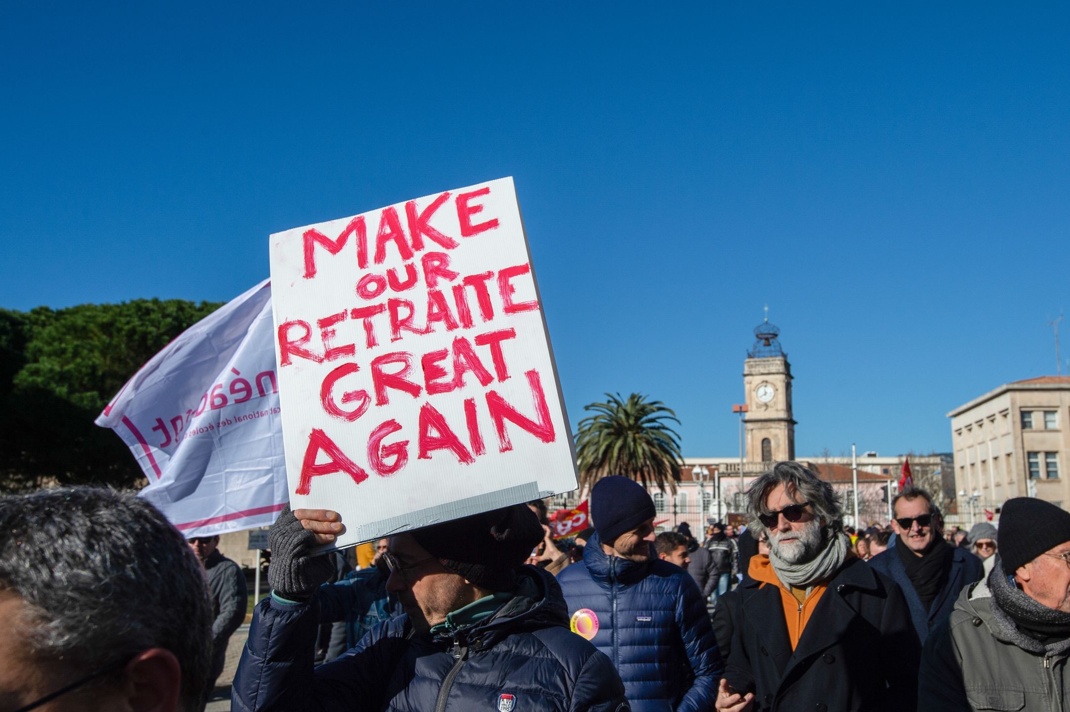 TOULON, FRANCE - 2023/01/19: A demonstrator holds a placard that says "make our retirement great again" during the demonstration. French Trade unions called for a general mobilization to protest against the the retirement and pension reforms being proposed by the government of Prime Minister Elisabeth Borne and President Emmanuel Macron. Union sources claimed 10,000 demonstrators, took to the streets in Toulon (Var).). (Photo by Laurent Coust/SOPA Images/LightRocket via Getty Images)