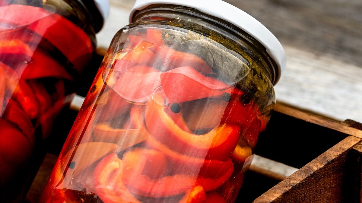 Wooden crate with glass jars with pickled red bell peppers.Preserved food concept, canned vegetables isolated in a rustic composition.Wooden crate with glass jars with pickled red bell peppers.Preserved food concept, canned vegetables isolated in a rustic composition.vladispasbackground, canned, canned peppers, canning food, canning jars, closeup, delicious, diet, fresh, glass, green, healthy, isolated, natural, nutrition, pepper, pickled red pepper, pickled vegetables, pickling, preserve, salt, salty, sour, sweet, traditional, variety, vegetables, vegetarian