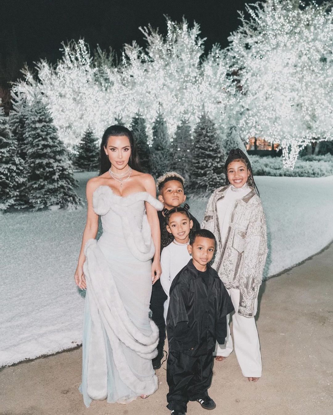Kim Kardashian with children at a holiday party