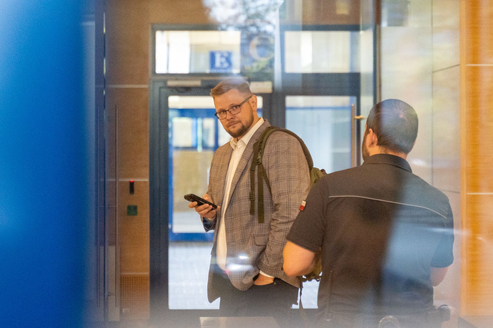 WARSAW, POLAND - 2024/08/27: MP Michal Wos looks into the camera as he enters the National Prosecutor's Office for questioning, where he is expected to face charges. Politician MP Michal Wos appeared at the National Prosecutor's Office in connection with an ongoing investigation into the Justice Fund. The prosecution intends to present charges against him, as a suspect. The case points on alleged irregularities in the distribution of Justice Fund resources, with particular focus on Wos's decision to allocate 6,507,125.00 United States Dollar for the purchase of the controversial Pegasus surveillance system. Prior to the hearing, at 10:45 AM, Wos held a press conference in front of the National Prosecutor's Office building, addressing the media about the allegations and the broader investigation. (Photo by Marek Antoni Iwanczuk/SOPA Images/LightRocket via Getty Images)