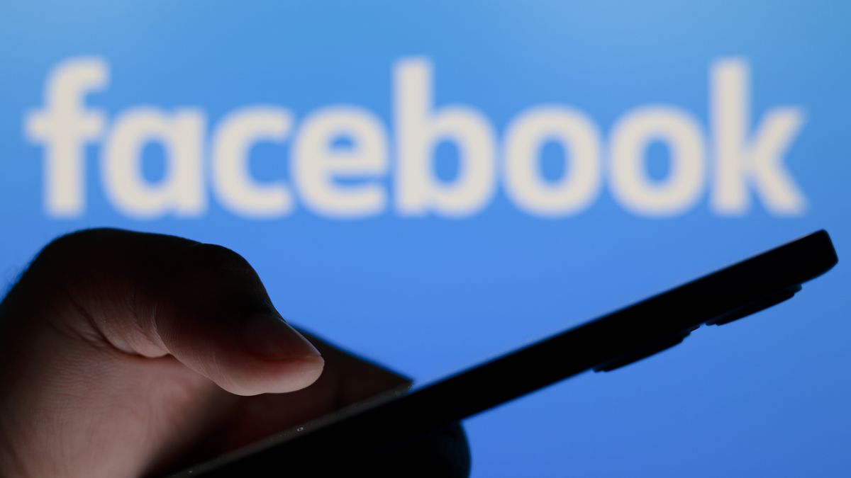 PARAGUAY - 2024/07/10: In this photo illustration, the Facebook logo seen in the background of a silhouette person holding a smartphone. (Photo Illustration by Jaque Silva/SOPA Images/LightRocket via Getty Images)