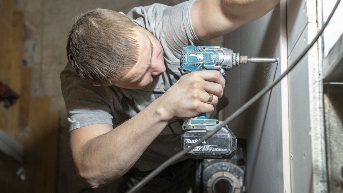 NEW YORK, NY - JANUARY 16: A construction worker uses an electric drill to attach a piece of sheetrock on a brownstone demolition-renovation job January 16, 2025 in the Brooklyn borough of New York City. The average price of a brownstone building in New York City, depending on the neighborhood, runs from $3.5 million to $10 million. (Photo by Robert Nickelsberg/Getty Images)