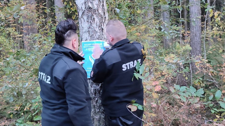 Kryzys na granicy z Białorusią. Strażacy z Michałowa umieszczają plakaty z informacją o punkcie pomocy dla migrantów