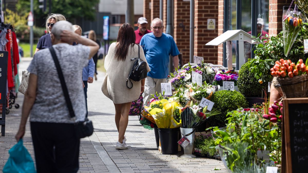 Shoppers pass a flower shop in Strood, UK, on Tuesday, July 16, 2024. Grocery price inflation fell to its lowest level since September 2021 in a further sign of easing cost pressures, ahead of a crucial decision by the Bank of England next month on whether to cut interest rates. Photographer: Chris Ratcliffe/Bloomberg via Getty Images