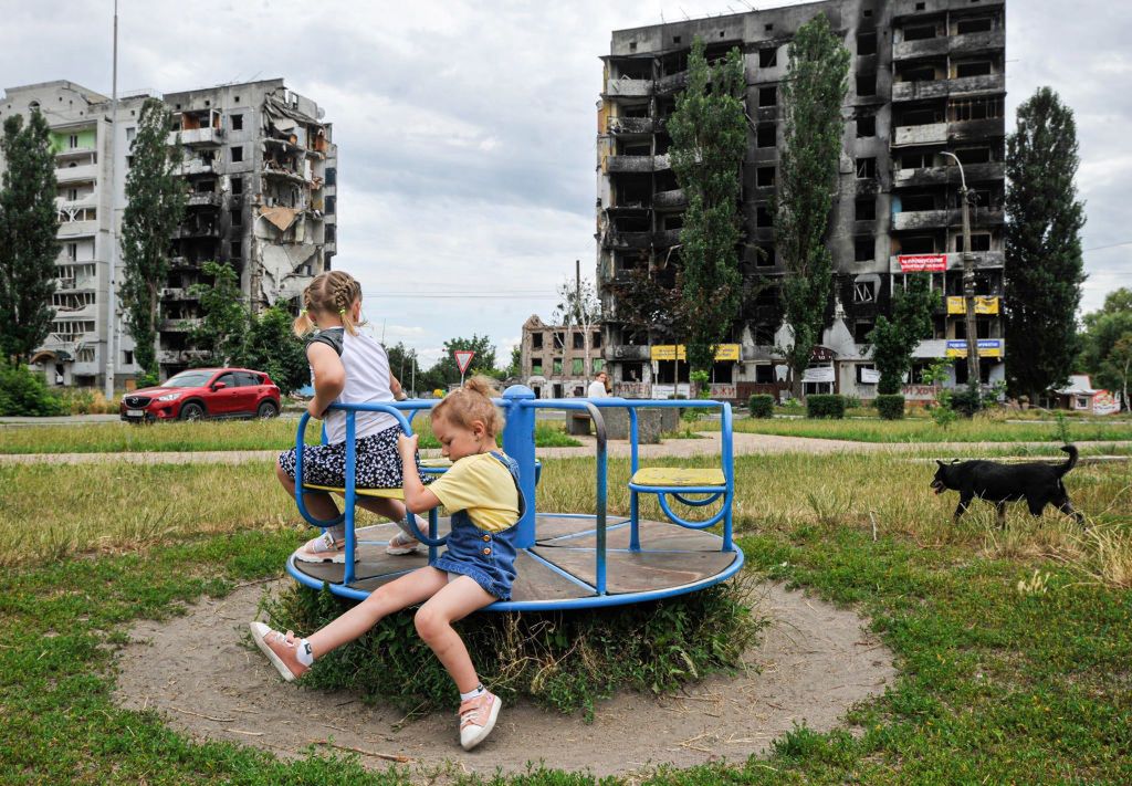 Children play at a playground near a residential areaBORODYANKA, UKRAINE - 2022/07/07: Children play at a playground near a residential area destroyed by the Russian army shelling in the city of Borodyanka, northwest of the Ukrainian capital Kyiv. (Photo by Sergei Chuzavkov/SOPA Images/LightRocket via Getty Images)SOPA Imageschildren, conflicts, damage, destroyed, devastation, invasion, kids, play, residential area, ruin, russian attack, russian invasion, ukraine - russia, war against ukraine, war crisis, young
