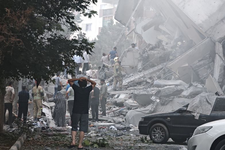 TEHRAN, IRAN - JUNE 13: People look over damage to buildings in Nobonyad Square following Israeli airstrikes on June 13, 2025 in Tehran, Iran. Iran's three top military generals were killed in the attacks that also targeted nuclear and military facilities, according to published reports. Israel described the strikes as preemptive to keep Iran from obtaining nuclear weapons, the reports said.  (Photo by Majid Saeedi/Getty Images)
