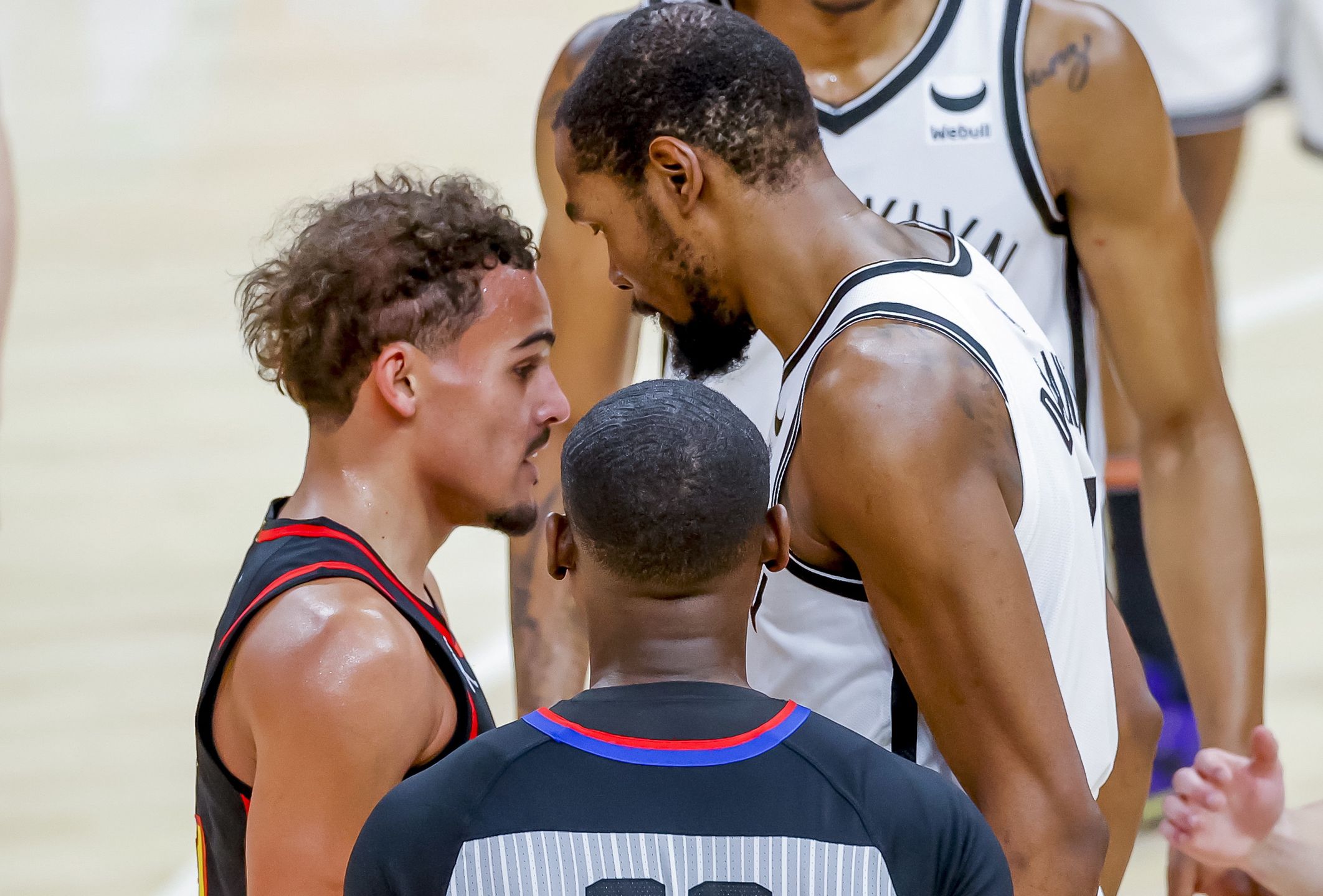 epa09635336 Atlanta Hawks guard Trae Young (L) and Brooklyn Nets forward Kevin Durant (R) are separated by referee James Williams (C) during the second half of the NBA basketball game between the Brooklyn Nets and the Atlanta Hawks at State Farm Arena in Atlanta, Georgia, USA, 10 December 2021.  EPA/ERIK S. LESSER SHUTTERSTOCK OUT Dostawca: PAP/EPA.