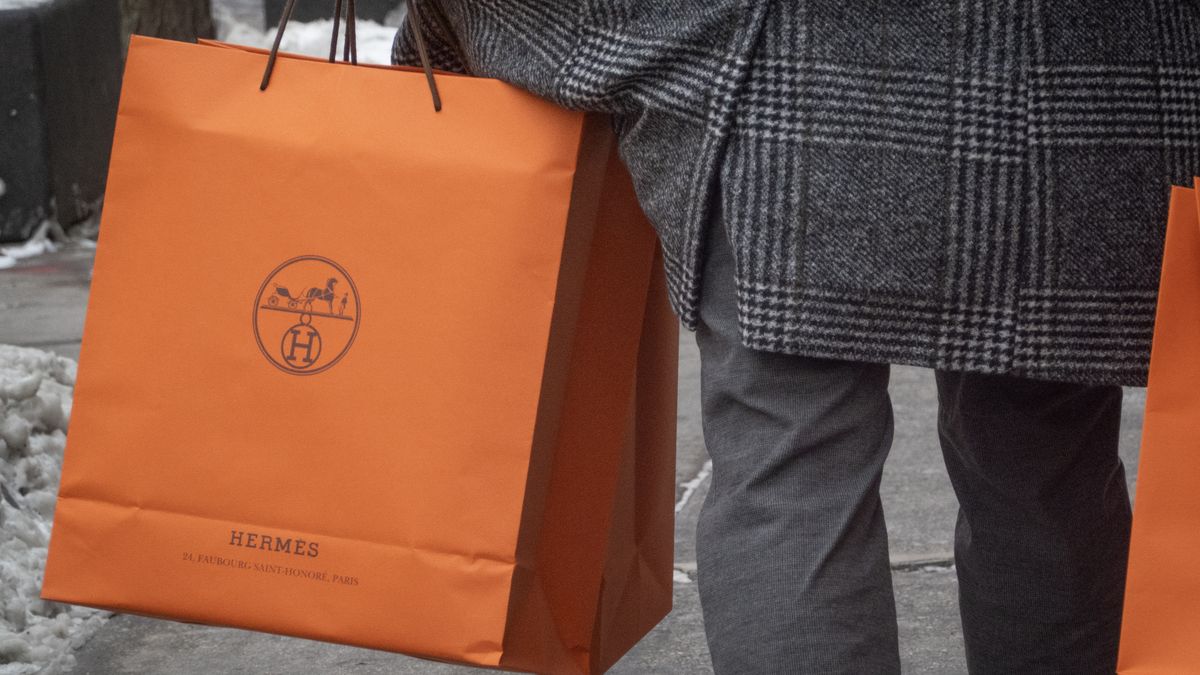 CHICAGO, ILLINOIS - FEBRUARY 14: A customer carries merchandise from a Hermes store on February 14, 2025 in Chicago, Illinois. Hermes, a Paris-based company, reported strong fourth-quarter sales for 2024. (Photo by Scott Olson/Getty Images)