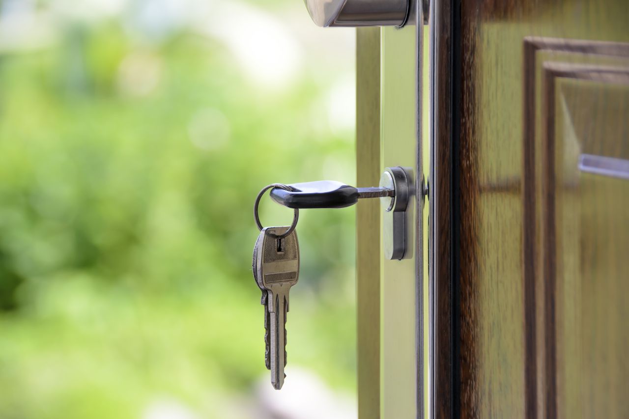 Keys and lock the door on the background of solar garden