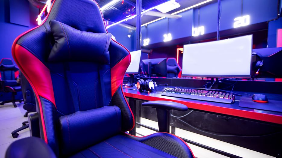 Fotel gamingowy gaming gracze  game chair blue color. Concept cyber sport arenaProfessional gamers cafe room with powerful personal computer game chair blue color. Concept cyber sport arena.PARILOV EGENIYgamer, game, cyber, online, tournament, pc, computer, multiplayer, display, gaming, internet, monitor, play, technology, teenager, competitive, esports, fun, talking, club, girl, group, team, arena, female, people, professional, blue, boy, man, cafe, championship, cybersport, keyboard, participation, young, player, dark, strategy, electronic, event, discussion, plan, row, show, blur, blured, background, armchair, red