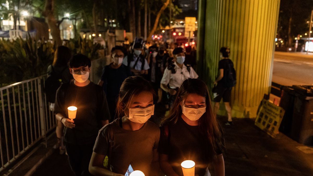 HONG KONG, CHINA - JUNE 04: People hold candles as they walk near the Victoria Park after police closed the venue where Hong Kong people traditionally gather annually to mourn the victims of China's Tiananmen Square crackdown in 1989, in the Causeway Bay district on June 4, 2021 in Hong Kong, China. The authorities have banned the gathering as they cite the coronavirus pandemic and vowed to stamp out any protests on the anniversary.  (Photo by Anthony Kwan/Getty Images)