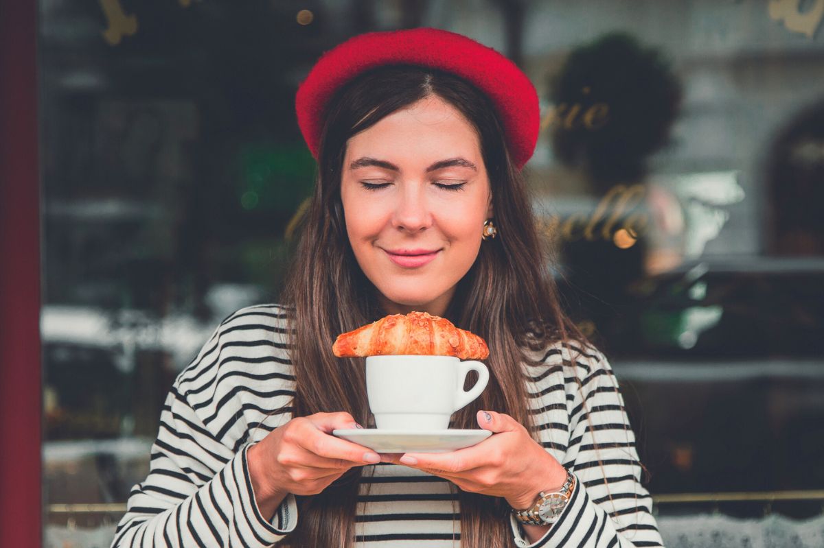 Woman with coffee and a croissant