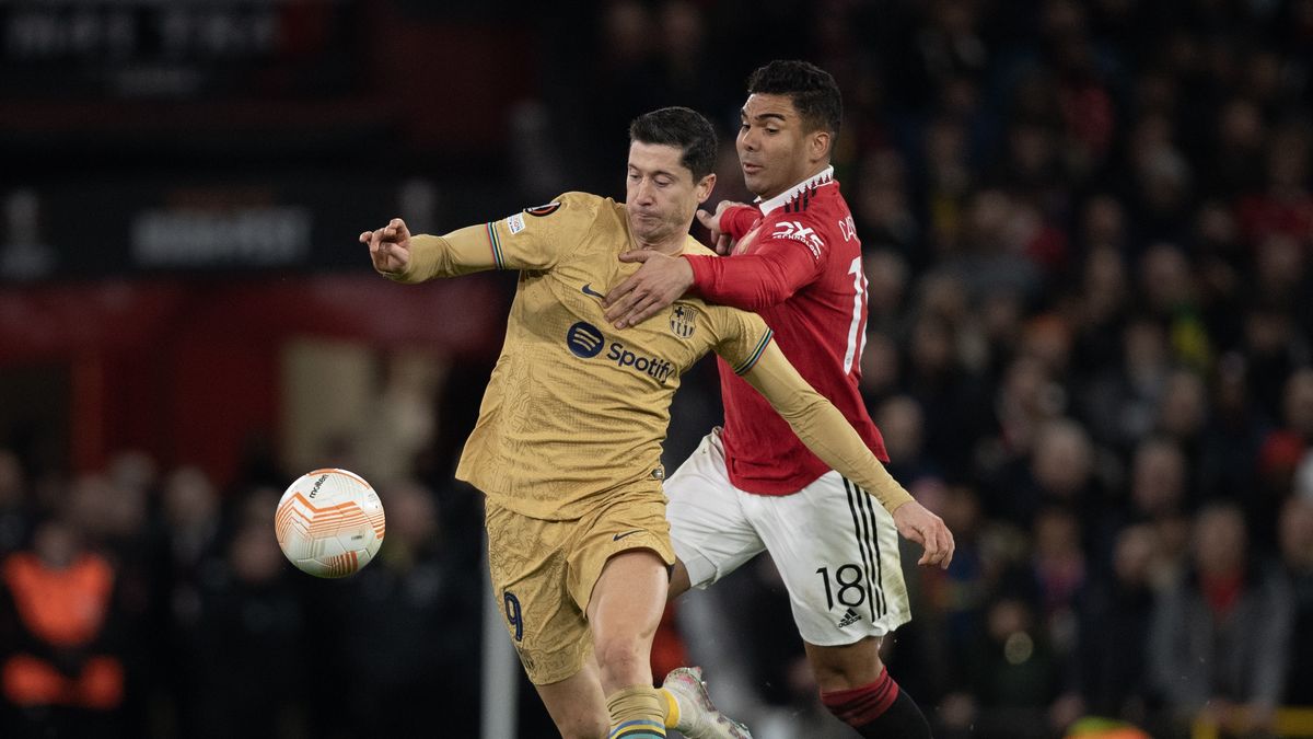 MANCHESTER, ENGLAND - FEBRUARY 23: Robert Lewandowski of Barcelona and Casemiro of Manchester United in action during the UEFA Europa League knockout round play-off leg two match between Manchester United and FC Barcelona at Old Trafford on February 23, 2023 in Manchester, United Kingdom. (Photo by Visionhaus/Getty Images)