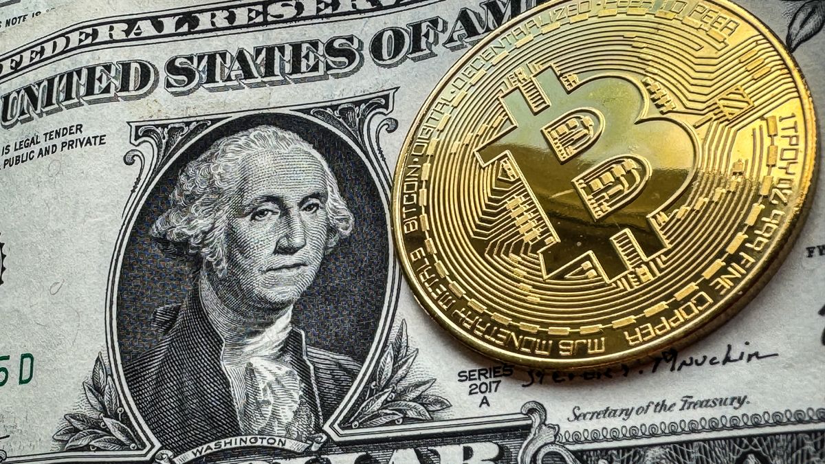 BATH, UNITED KINGDOM - NOVEMBER 05: In this photo illustration a novelty Bitcoin token is photographed on a US Dollar bank note, on November 5, 2023 in Bath, England. Since the start of the conflict in Ukraine, cryptocurrency analysts say millions of US dollars has so far been donated to the Ukrainian war effort through anonymous Bitcoin donations, with the Ukrainian government, and many NGOs and volunteer groups all advertising their Bitcoin wallet addresses online.  However, fears have also been raised that the use of cryptocurrencies, such as Bitcoin, maybe used by the Russian government to circumnavigate the tough economic sanctions that have been imposed. (Photo by Matt Cardy/Getty Images)