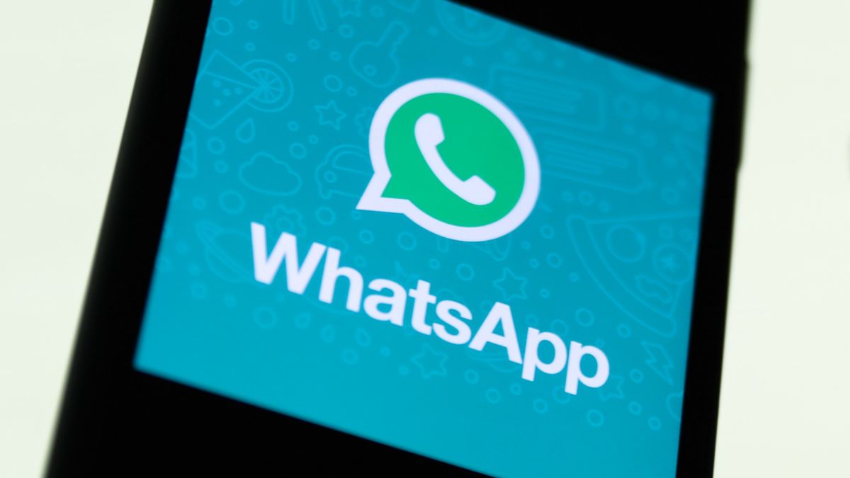 WhatsApp logo displayed on a phone screen and conversation on the WhatsApp displayed on a phone screen in the background are seen in this illustration photo taken in Krakow, Poland on August 27, 2021. (Photo Illustration by Jakub Porzycki/NurPhoto via Getty Images)
