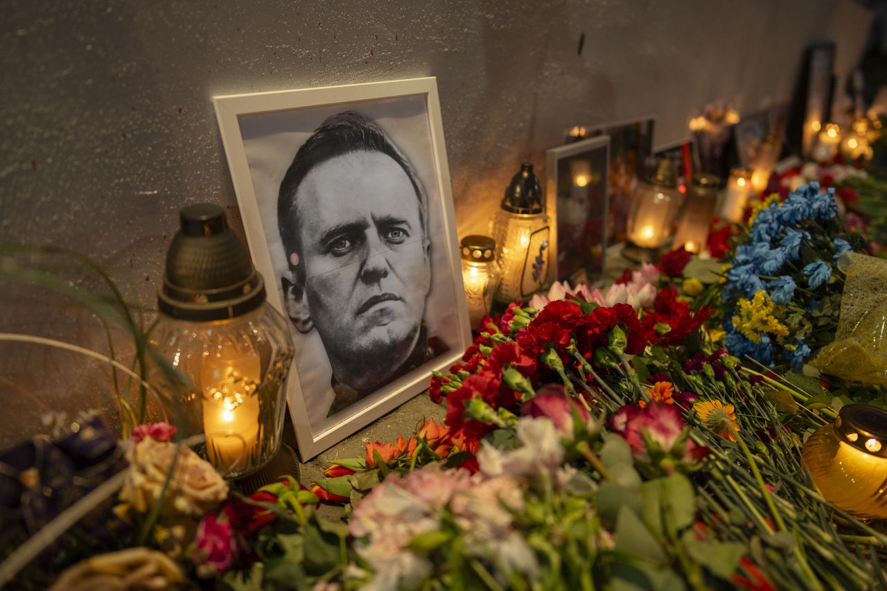 Photographs of the late political opposition activist and former presidential candidate Alexei Navalny are seen at a makeshift shrine with candles at the Russian embassy in Warsaw, Poland on 27 Februar, 2024. (Photo by Jaap Arriens/NurPhoto via Getty Images)