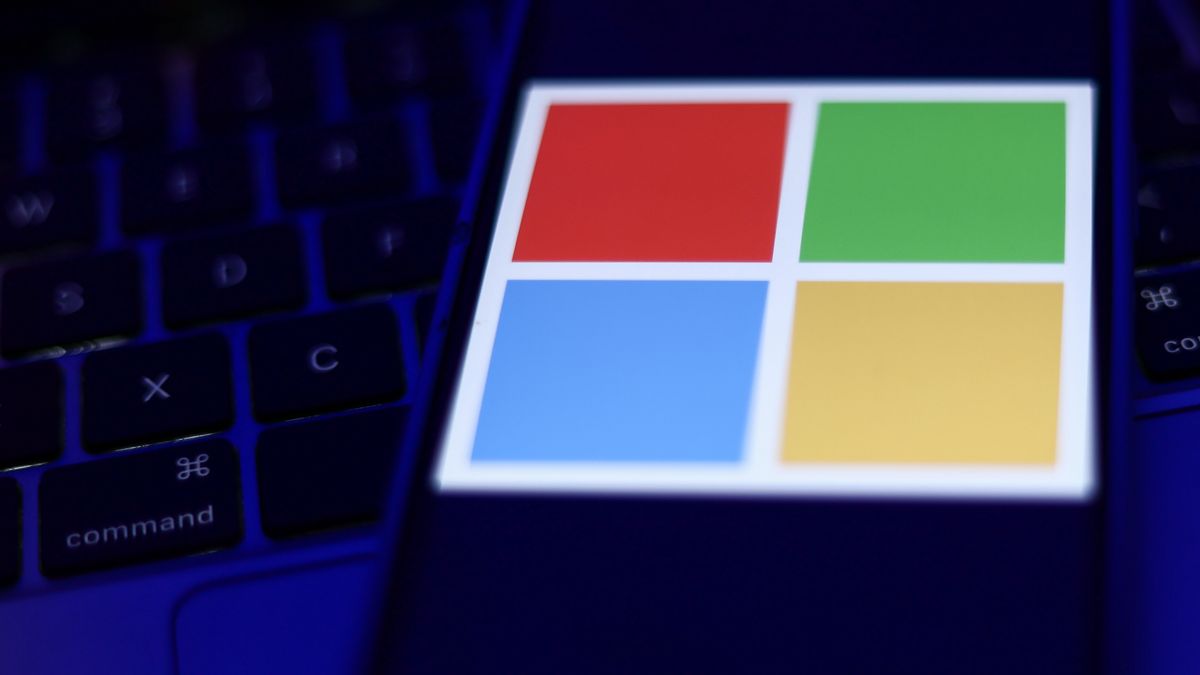 Microsoft logo displayed on a phone screen and a laptop keyboard are seen in this illustration photo taken in Krakow, Poland on September 25, 2024. (Photo by Jakub Porzycki/NurPhoto via Getty Images)
