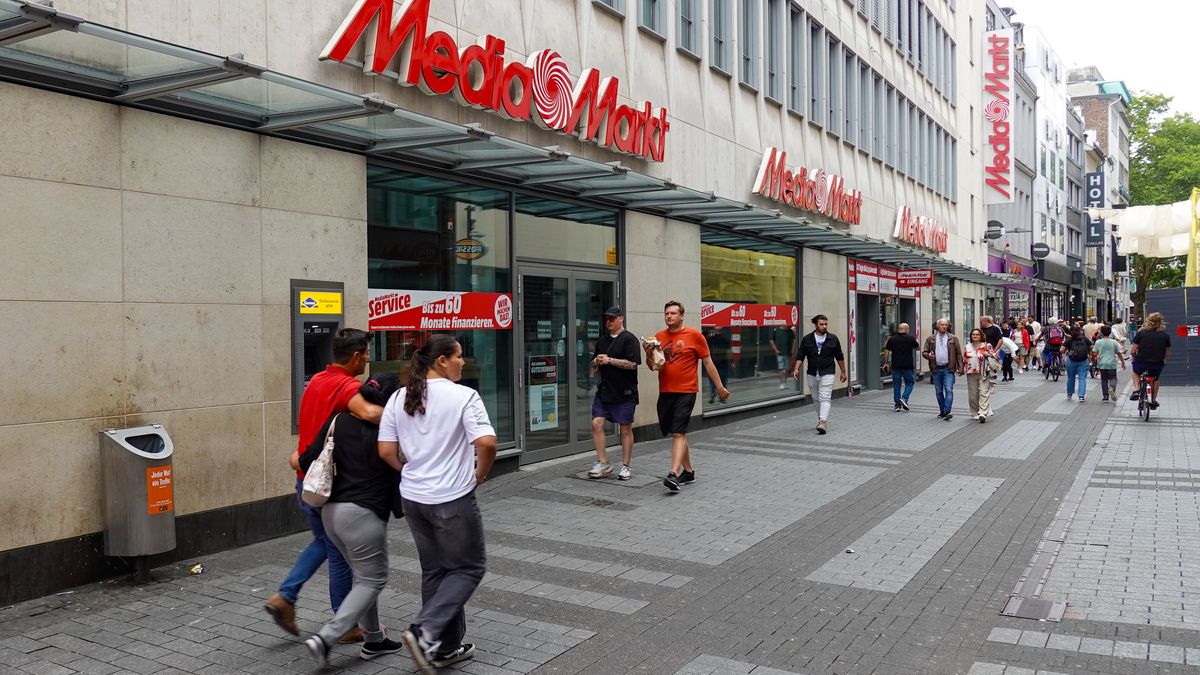 People walk past the Media Markt electronics retail store on a shopping street in Cologne, North Rhine-Westphalia, Germany, on August 3, 2025. (Photo by Michael Nguyen/NurPhoto via Getty Images)