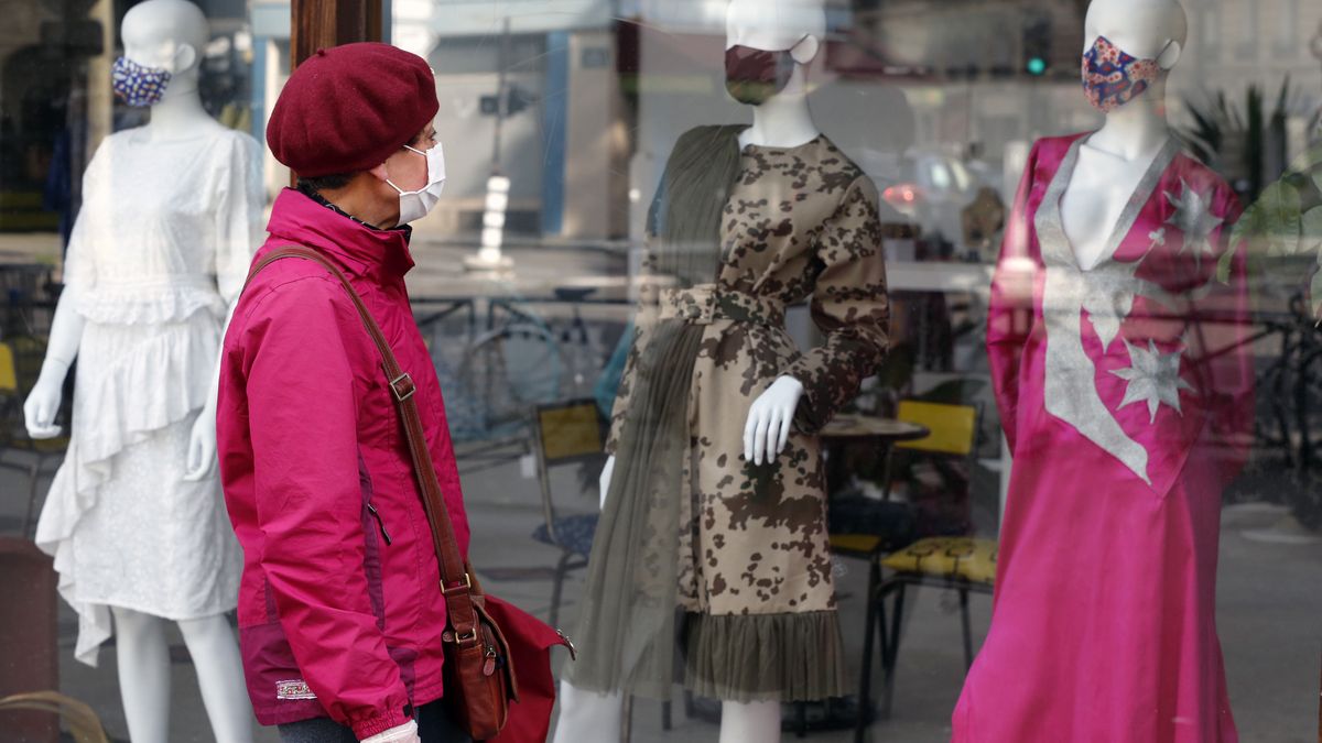 PARIS, FRANCE - MAY 13: A woman wearing a protective face mask looks at shop mannequins wearing protective face masks displayed in the window of a fashion store as France is slowly reopening after almost two months of strict lockdown throughout the country due to the epidemic of coronavirus (COVID 19) on May 13, 2020 in Paris, France. Facial mask has become a fashion accessory with the Coronavirus epidemic. France has begun a gradual easing of its lockdown measures and restrictions amid the coronavirus (COVID-19) outbreak. The Coronavirus (COVID-19) pandemic has spread to many countries across the world, claiming over 292,000 lives and infecting over 4.2 million people.